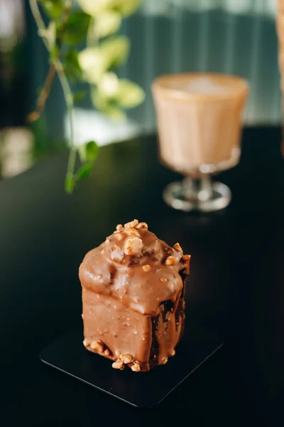 Chocolate cupcake with nuts and chocolate glaze.