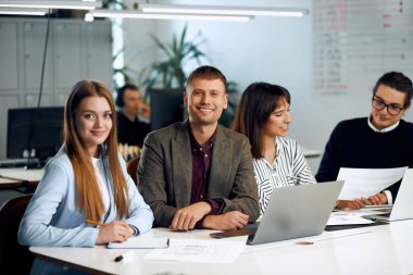 A team of young happy office workers working together and enjoying their work.