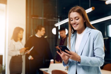Happy office worker chatting on phone.