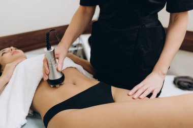 Cosmetologist. Lymphatic drainage massage LPG apparatus process. Woman getting massage in a beauty SPA salon. LPG, and body contouring treatment in clinic