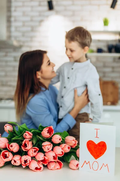 I love my mom! Cute son congratulate his mother with Mother`s day. Spending time together at home. Happy family concept