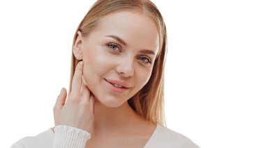 Beauty skin. Head and shoulders of blond woman model, touching glowing, hydrated facial skin, apply toner, skin cream or lotion for healthy look, after shower portrait, white background.