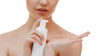 Portrait of cheerful laughing woman applying foam for washing on her face. Lovely blonde with attractive appearance. Skincare spa relax concept.