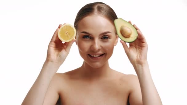 Beautiful Young Blonde Girl Holds Half Avocado Half Lemon Her — Stockvideo