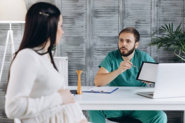 Hamile kadın klinikte doktoru ziyaret ediyor. Geçmişinde jinekolog olan çekici bir kadın..