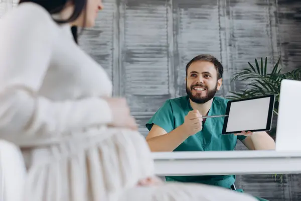 stock image Pregnant woman visiting doctor in clinic. Attractive woman with gynecologist on background.