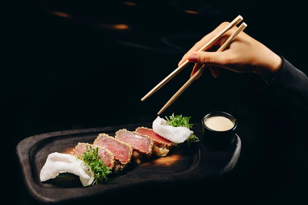 stock image Tuna steaks with tropical chutney and Chinese chopsticks in hand