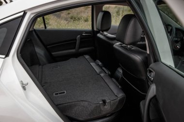 Prague, Czech republic - July 20, 2021: White Mazda 6 gh Clean and spacious car interior showing back seats folded down creating a large cargo area clipart