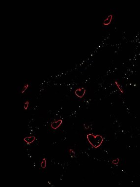 Red heart shaped lights create a romantic atmosphere in the night sky above prague, czechia Valentines day copy space clipart