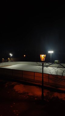 Prague, Czech republic - February 9, 2023: havlickovy sady ice rink glowing under moonlit sky, casting romantic winter evening illumination during valentine's celebration clipart