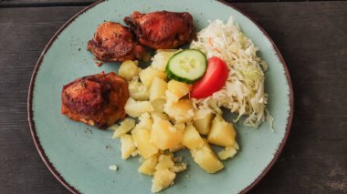 Lezzetli kızarmış tavuk haşlanmış patates, salatalık ve domates dilimleri ve lahana salatası ile servis edilir. Geleneksel bir Czech yemeği sunar.