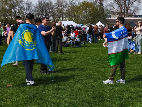 Prag, Çek Cumhuriyeti - 12 Nisan 2025: İran 'ın yeni yılı olan Nowruz' u Pankrac Park, Prag 'da Kazak ve Özbek bayrakları gururla sergilenerek kutlayan insanlar