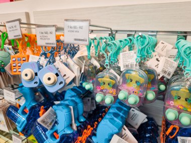 Prag, Çek Cumhuriyeti - 30 Nisan 2025: Kameralar ve yıldız şeklinde uçan kaplan anahtarlıkları, su tabancalarıyla birlikte Prag, Czechia 'daki bir hediyelik eşya dükkanında sergilenmektedir.