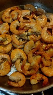 Taze karidesler bir tavada pişiyor ve İtalya 'nın bibibione kentinin yaz aylarında aşçılık sahnesine bir göz atıyorlar. Yüksek kaliteli FullHD görüntüler