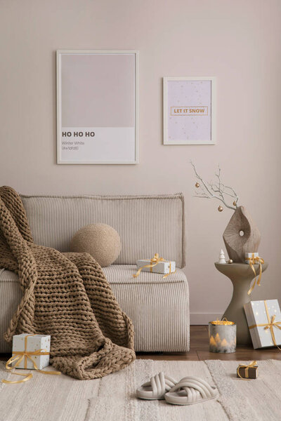 Christmas cozy living room interior with beige sofa, boucle armchair, christmas decoration, mock up poster frames, stars, gifts and elegant accessories. Santa claus is coming. Template. Home decor. 