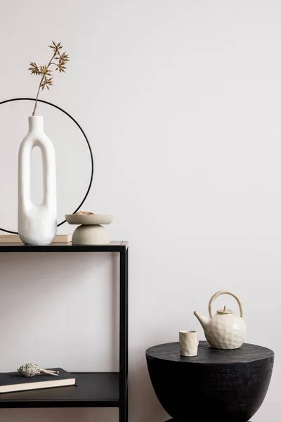 stock image Aesthetic interior of living room with copy space, white wall, round black coffee table, simple console with stylish accessories. Home decor. Template. 