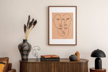 Interior design of living room interior with mock up poster frame, wooden commode, lamp on the wooden stand, books, brown sofa and elegant personal accessories. Home decor. Template. 