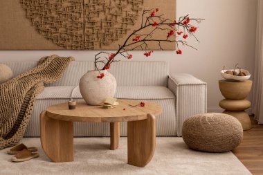 Creative composition of living room interior with wall art paint, modern beige sofa, round wooden coffee table, vase with rowan, brown pouf, slippers and personal accessories. Home decor. Template. clipart