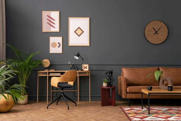 Creative composition of living room interior with mock up poster frame,  brown sofa, wooden desk, stylish armchair, wooden wall, coffee table, rug and personal accessories. Home decor. Template.