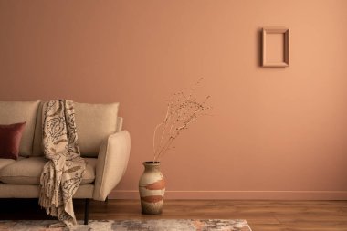 Minimalist composition of living room interior with mock up poster frame, beige sofa, vase with dried flowers, rug, patterned plaid, pillow, pink wall and personal accessories. Home decor. Template. 