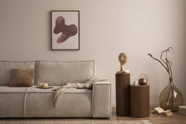 Interior design of elegant composition with mock up poster frame, modern beige sofa, brown pillow, elegant wooden stand, glass vase with dried flowers, patterned carpet, books and personal accessories. Home decor. Template. 