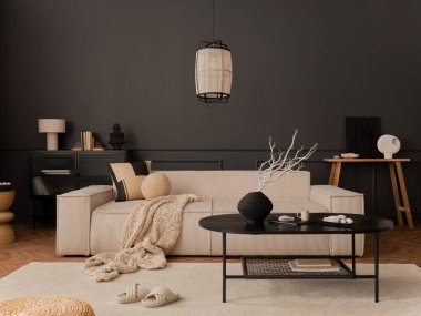 Asthetic composition of living room interior with modular sofa, black coffee table, white armchair, carpet, pouf, dark wall and personal accessories. Home decor. Template.  