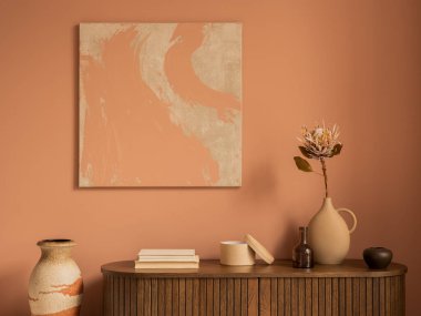 Creative composition of living room interior with mock up poster frame, wooden sideboard, vase with dried flower, books, casket, pink wall and personal accessories. Home decor. Template.