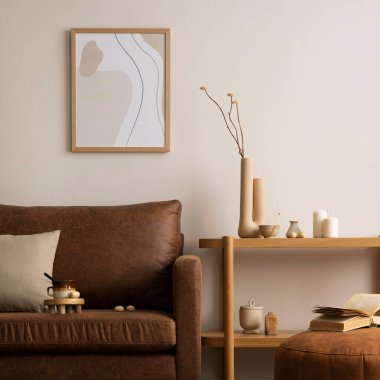 Interior design of stylish and elegant room with brown sofa, pouf, wooden shelf, book, mock up poster frame, decoration and personal accessories. Warm home decor. Template.