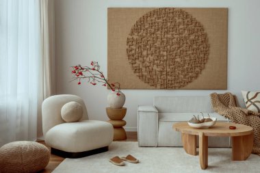 Living room interior with mock up poster frame, beige sofa, round wooden coffee table, rug, pouf, vase with rowan, rounded shapes armchair, braided plaid and personal accessories. Home decor. Template