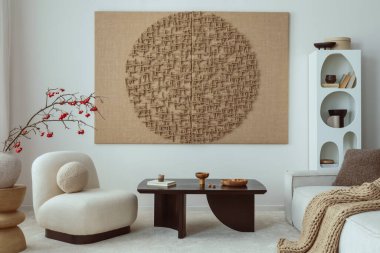 Aesthetic composition of japandi living room interior with mock up poster frame, modern black coffee table, vase with rowan, rounded shapes armchair and personal accessories. Home decor. Template.
