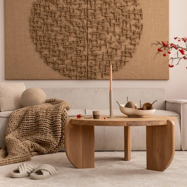 stock image Interior design of japandi living room with mock up poster frame, modular beige sofa, vase with rowan, round wooden coffee table, braided brown plaid and personal accessories. Home decor. Template. 