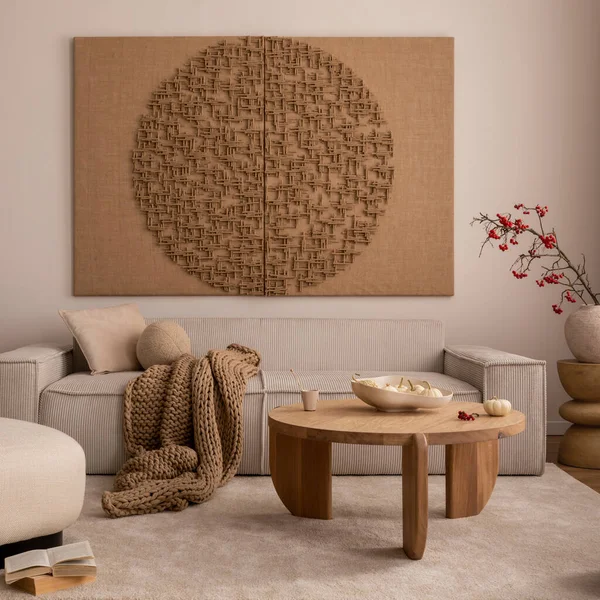 Creative composition of living room interior with mock up poster frame, beige sofa, wooden coffee table, rounded shapes armchair, vase with rowanberry and personal accessories. Home decor. Template