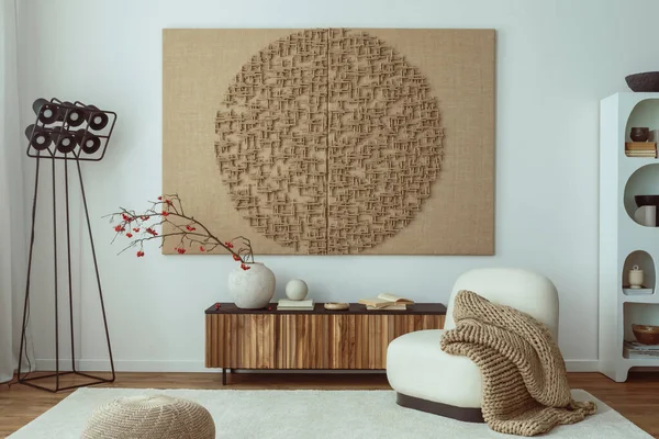 Interior design of living room interior with mock up poster frame, white armchair, wooden sideboard, sculpture, rug, black modern lamp and personal accessories. Home decor. Template.