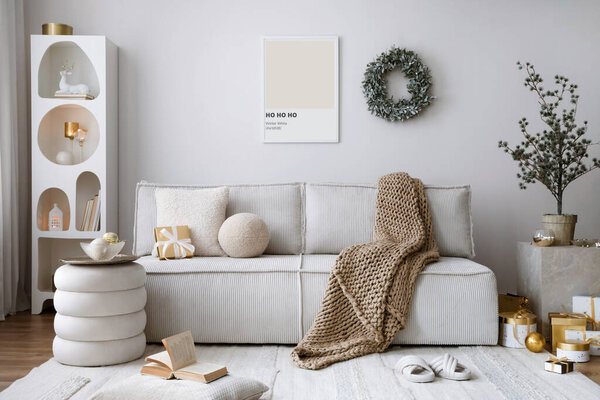 Domestic and cozy christmas living room interior with corduroy sofa, white shelf, mock up poster frame, christmas decoration, wreath, stars, gifts and accessories. Home decor. Family time. Template.