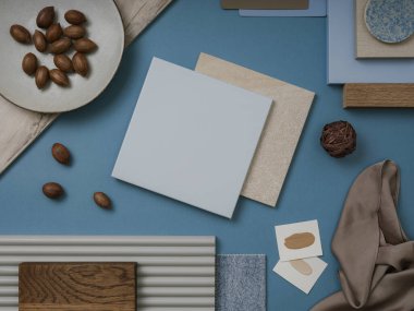 Tekstil ve boya örnekleriyle mavi, kahverengi ve bej renk paleti, lamella paneller ve fayanslar ile zarif düz konum. Mimar ve iç mimar bozumu. Üst Manzara. Boşluğu kopyala.