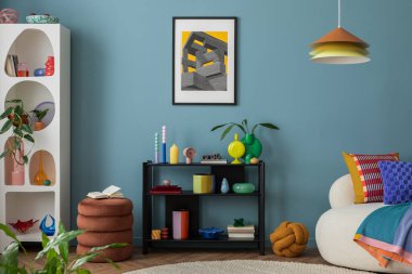 Modern and colorful interior of living room with design boucle sofa, mock up poster, shelf, plants, decorations and personal stuff. Home decor.	
