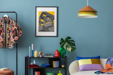 Modern and colorful interior of living room with design boucle sofa, mock up poster, shelf, plants, decorations and personal stuff. Home decor.	