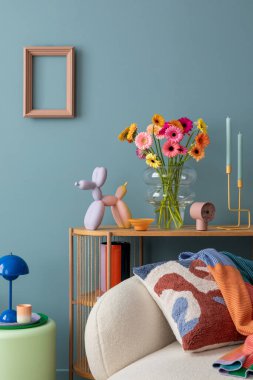 Parlak ve davetkar bir yaşam alanı. Taze çiçekler, renkli bir dekor ve kalın bir yastıkla rahat beyaz bir kanepe, modern estetik aksanla oyuncu aksanları harmanlıyor..