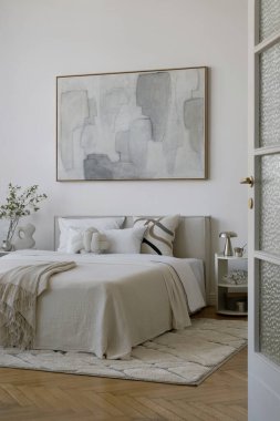 Geometrik yastıklı, nötr yatak odası ve heykel aksesuarlarıyla çağdaş yatak odası..