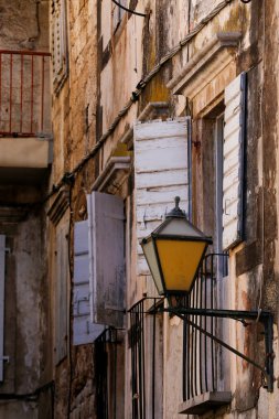 Picturesque narrow street with stone houses. Scene with old houses and old narrow alley. Trogir, Dalmatia, Croatia, Europe