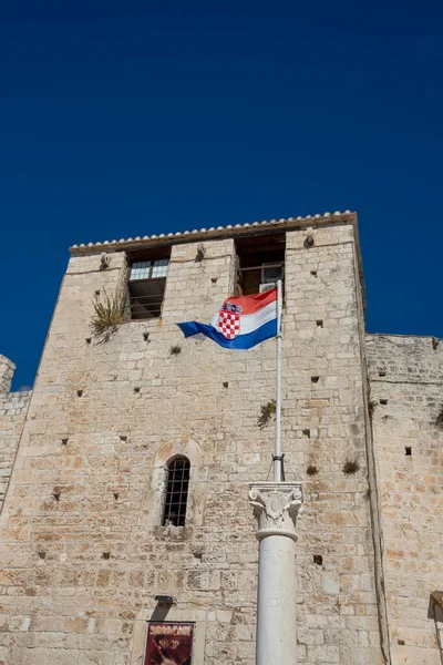 stock image Croatian flag in front tower of the old city walls of Trogir, Croatia