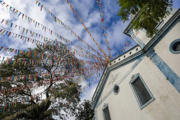 stock image Church of Our Lady of Black Men of Penha adorned with colorful pennants for outdoor mass and folkloric festival, in Penha neighborhood, Sao Paulo city, Brazil
