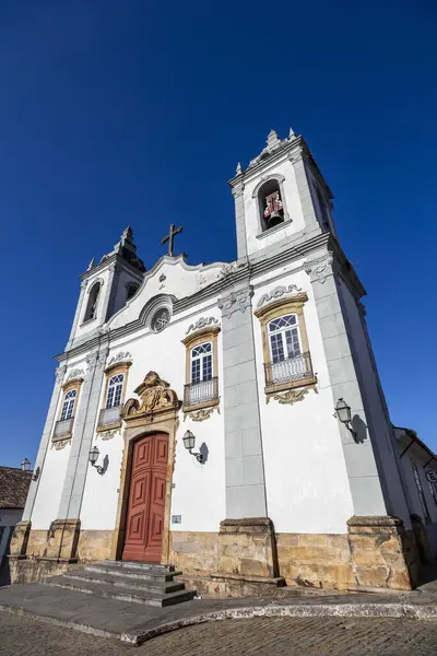 stock image Facade of the beautiful baroque church of Nossa Senhora das Merces in the historic center of Sao Joao del Rei, under blue sky.