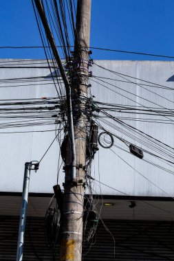 messy electricity wires on the pole, The chaos of cables and wires on an electric pole in Sao Paulo city, Brazil