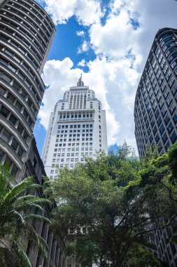 Old Center of Sao Paulo, Brazil. Altino Arantes Building (white), also known as Banespa or Santander and the Martinelli Building (brown) seen from a low angle, on a sunny day clipart