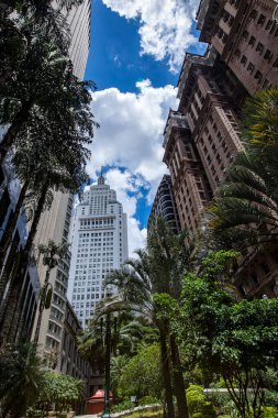 Old Center of Sao Paulo, Brazil. Altino Arantes Building (white), also known as Banespa or Santander and the Martinelli Building (brown) seen from a low angle, on a sunny day clipart