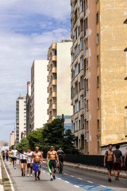 Sao Paulo, Brazil - jan 26, 2024: People enjoying the weekend with outdoors activities at elevated highway known as Minhocao (Elevado Presidente Joao Goulart) while closed for cars clipart