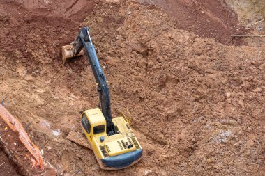 Brezilya 'nın Sao Paulo kentindeki temel inşaatı için kırmızı kil çıkarmaya çalışan kazıcı.