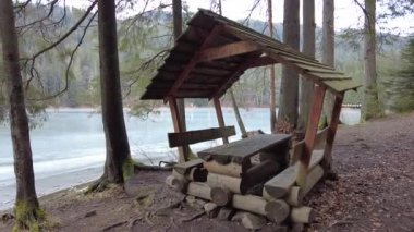 A forest path in the mountains of Ukraine. High mountain lake Synevyr. Wooden gazebo in the mountains. Old wooden house in the forest.