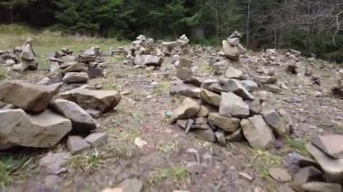 A forest path in the mountains of Ukraine. High mountain lake Synevyr. Stone glade, stones for meditation. Stone graves.